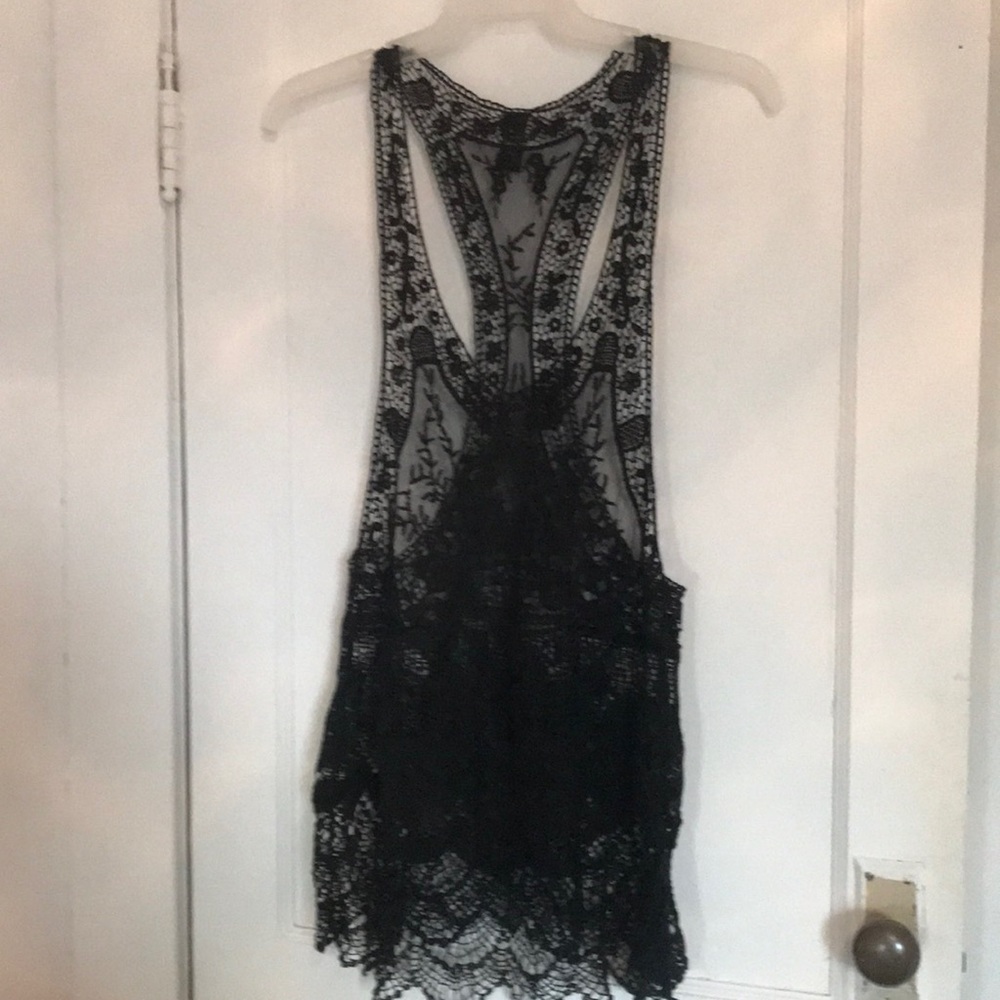 Bathing suit cover up with scalped edges on the bottom .